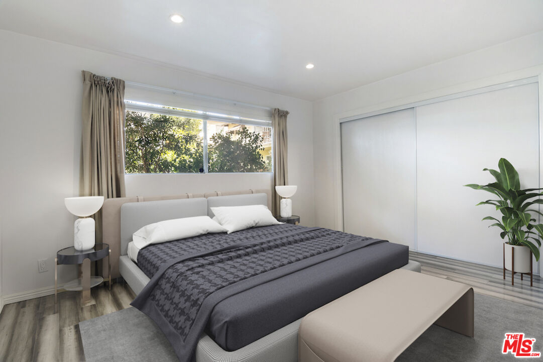 923 17th Street, Unit 3 Santa Monica, CA 90403 - Photo 14 of 22 a bedroom with a large bed and a potted plant