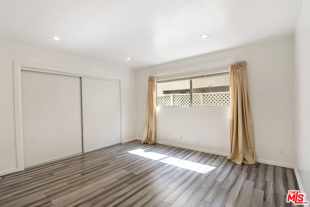 923 17th Street, Unit 3 Santa Monica, CA 90403 - Photo 18 of 22 an empty room with wooden floor and windows