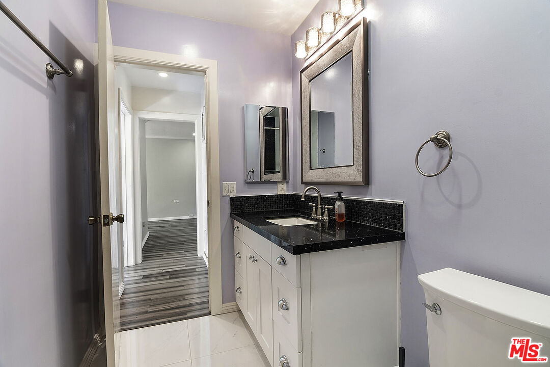 923 17th Street, Unit 3 Santa Monica, CA 90403 - Photo 20 of 22 a bathroom with a sink and a mirror