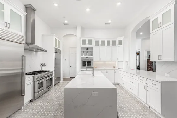 a large kitchen with stainless steel appliances kitchen island granite countertop a large counter top stainless steel appliances and cabinets