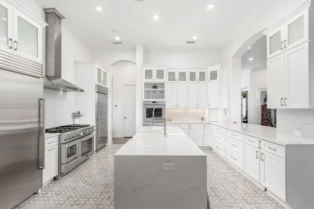 a large kitchen with stainless steel appliances kitchen island granite countertop a large counter top stainless steel appliances and cabinets