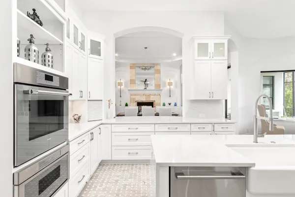 a kitchen with stainless steel appliances kitchen island granite countertop a sink and cabinets with wooden floor
