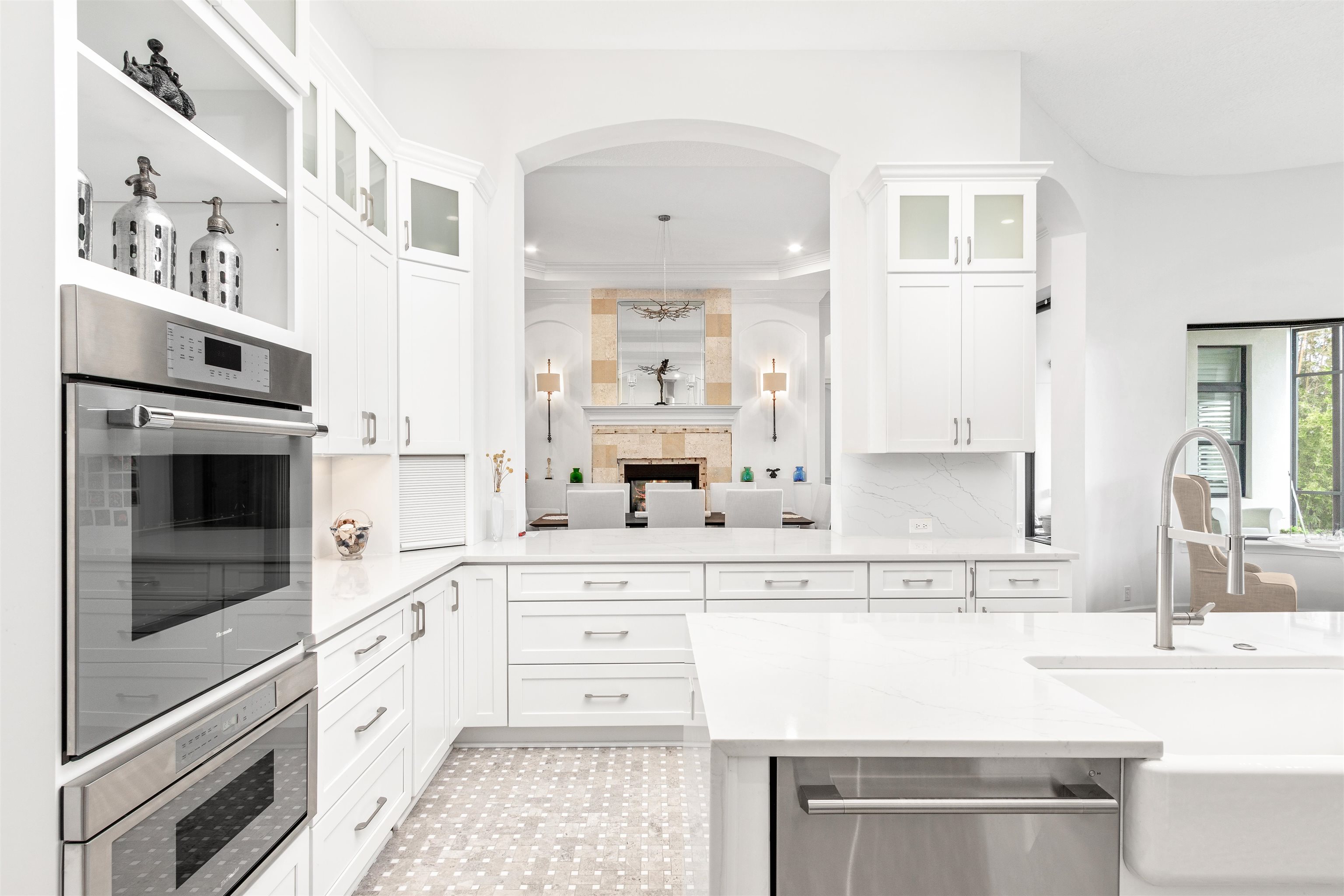 151 Pelican Reef Drive St. Augustine, FL 32080 - Photo 12 of 29 a kitchen with stainless steel appliances kitchen island granite countertop a sink and cabinets with wooden floor