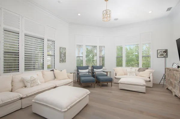 a living room with furniture and large windows