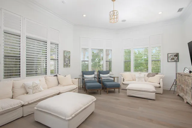 a living room with furniture and large windows