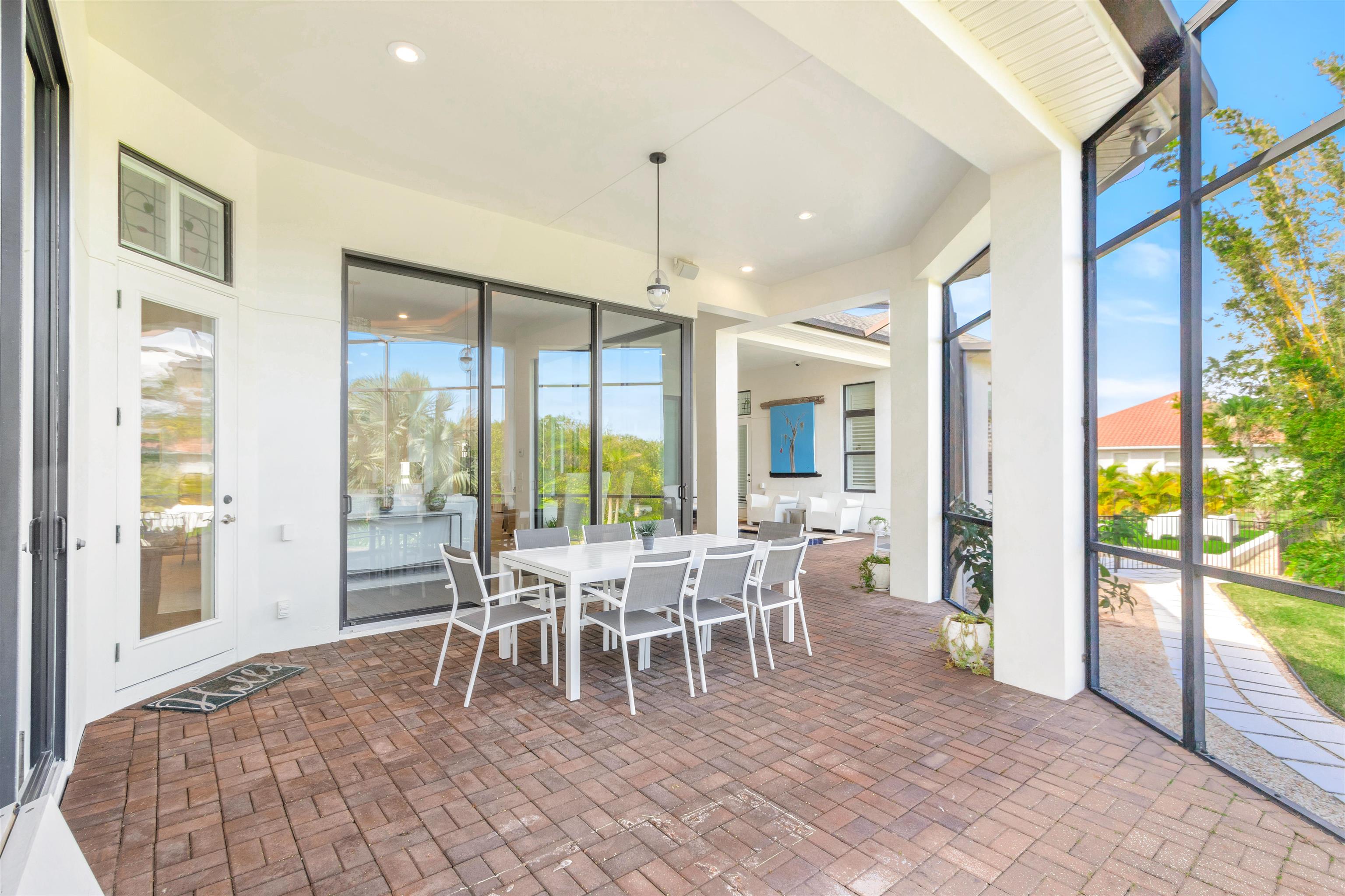 151 Pelican Reef Drive St. Augustine, FL 32080 - Photo 15 of 29 a dining room with furniture a chandelier and wooden floor