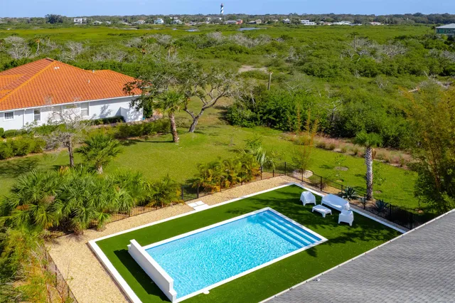 an aerial view of residential houses with outdoor space and river