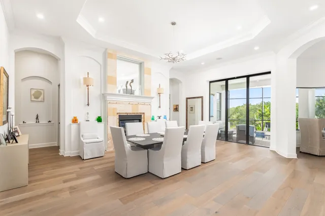 a living room with fireplace furniture and a large window