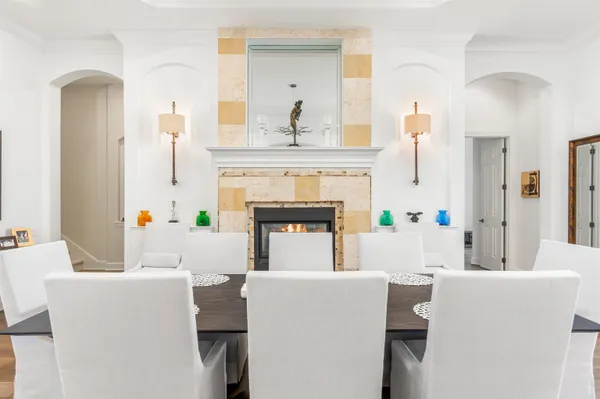 a living room with a fireplace and a chandelier