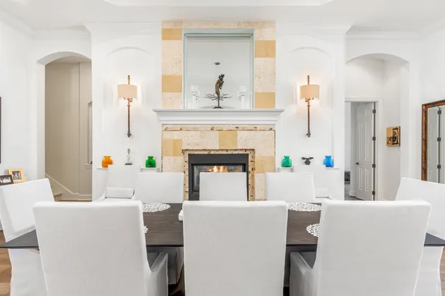 a living room with a fireplace and a chandelier