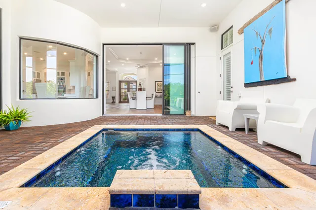 a living room with kitchen island granite countertop furniture and a large window