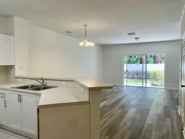 a kitchen that has a sink a stove and cabinets