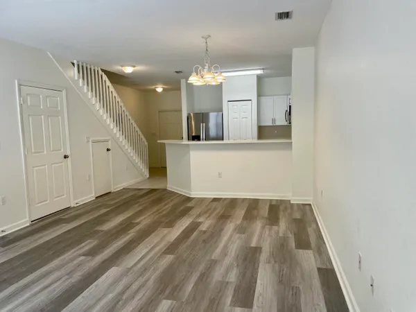 a view of empty room with wooden floor