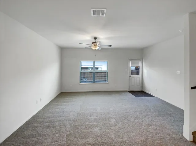 a view of a room with wooden floor and a window