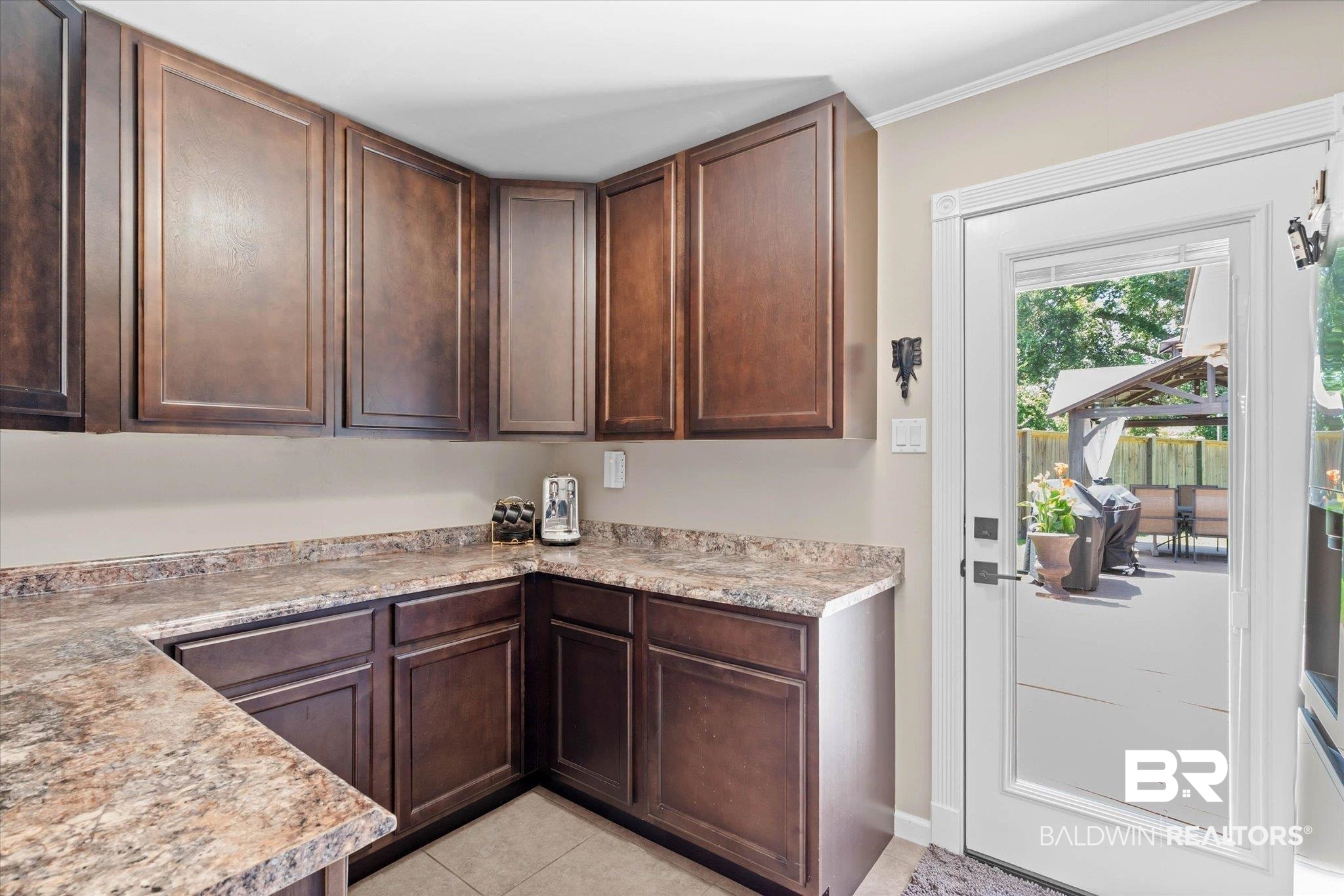 101 Ann Street Daphne, AL 36527 - Photo 22 of 38 Brown wood-finish cabinetry with textured countertops