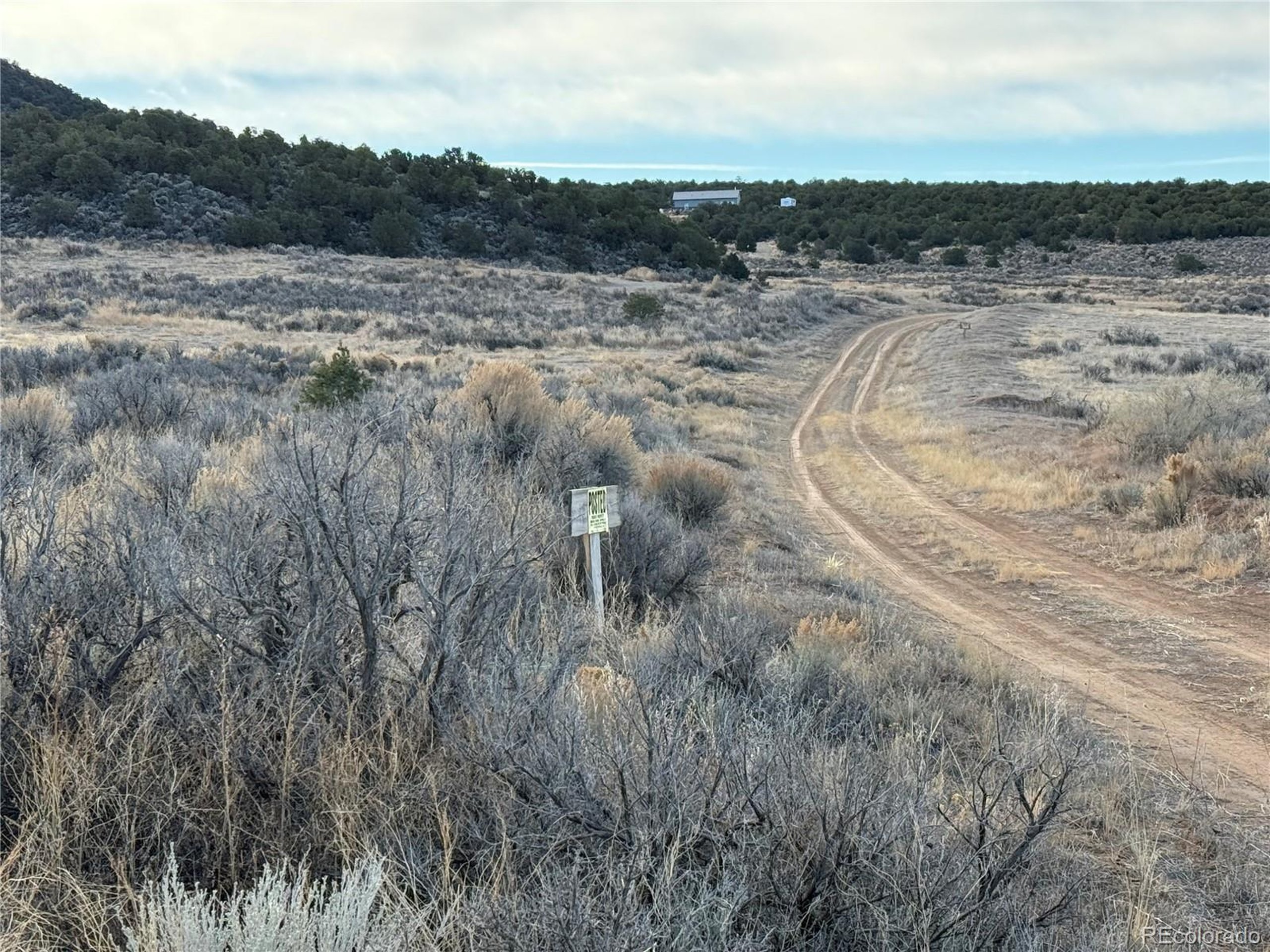 54 Old Stage Coach Road San Luis, CO 81152 - Photo 5 of 20 a view of a dry yard with wooden fence