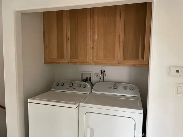 a bathroom with a granite countertop toilet and a sink