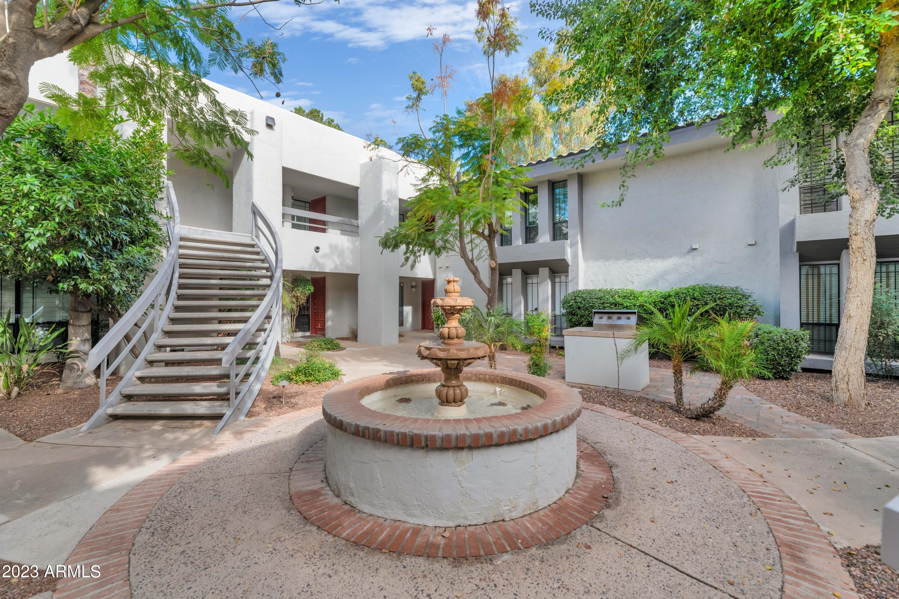a view of a house with a fountain and a fountain