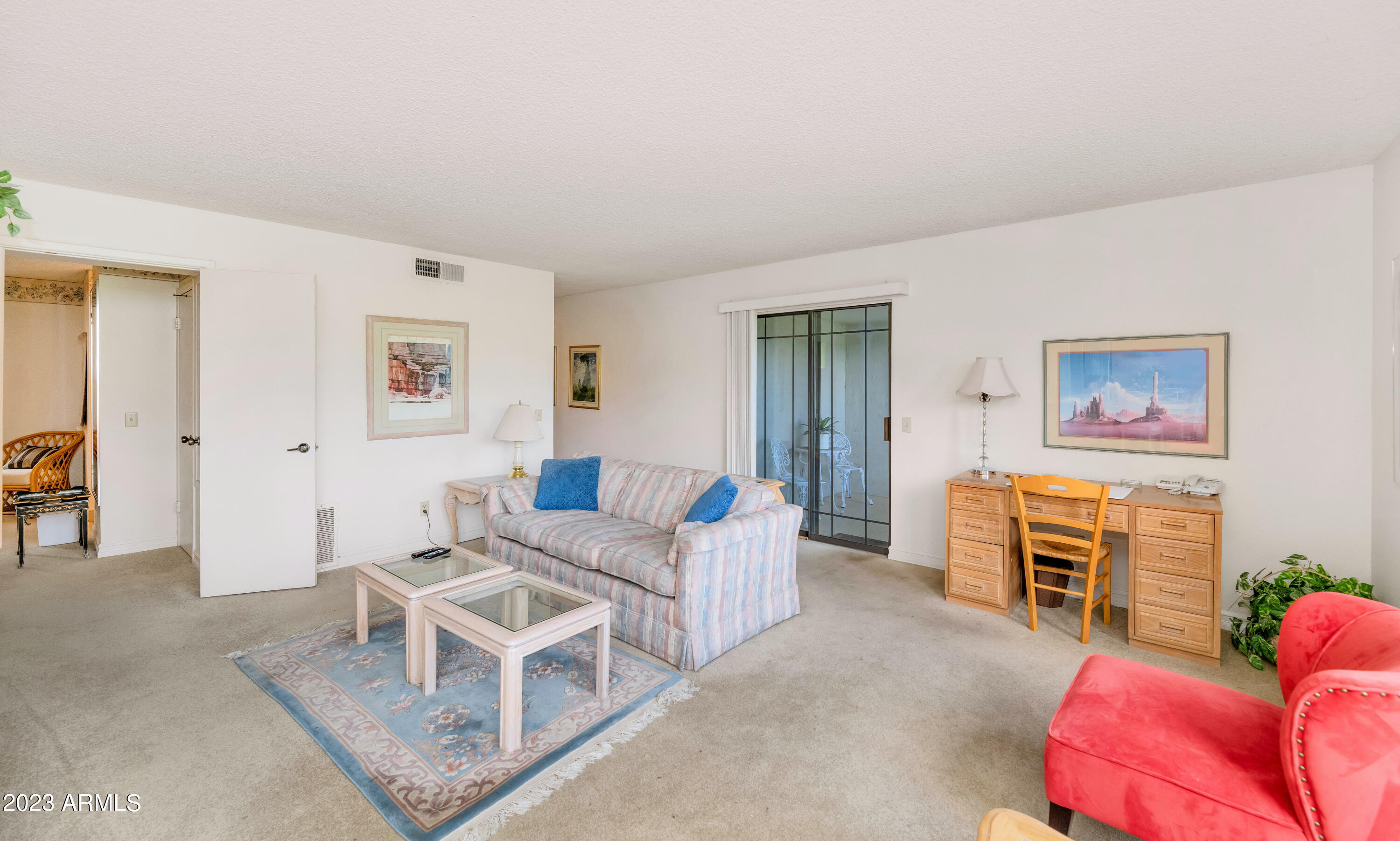 5223 North 24th Street, Unit 105 Phoenix, AZ 85016 - Photo 5 of 22 a living room with furniture a flat screen tv and a window