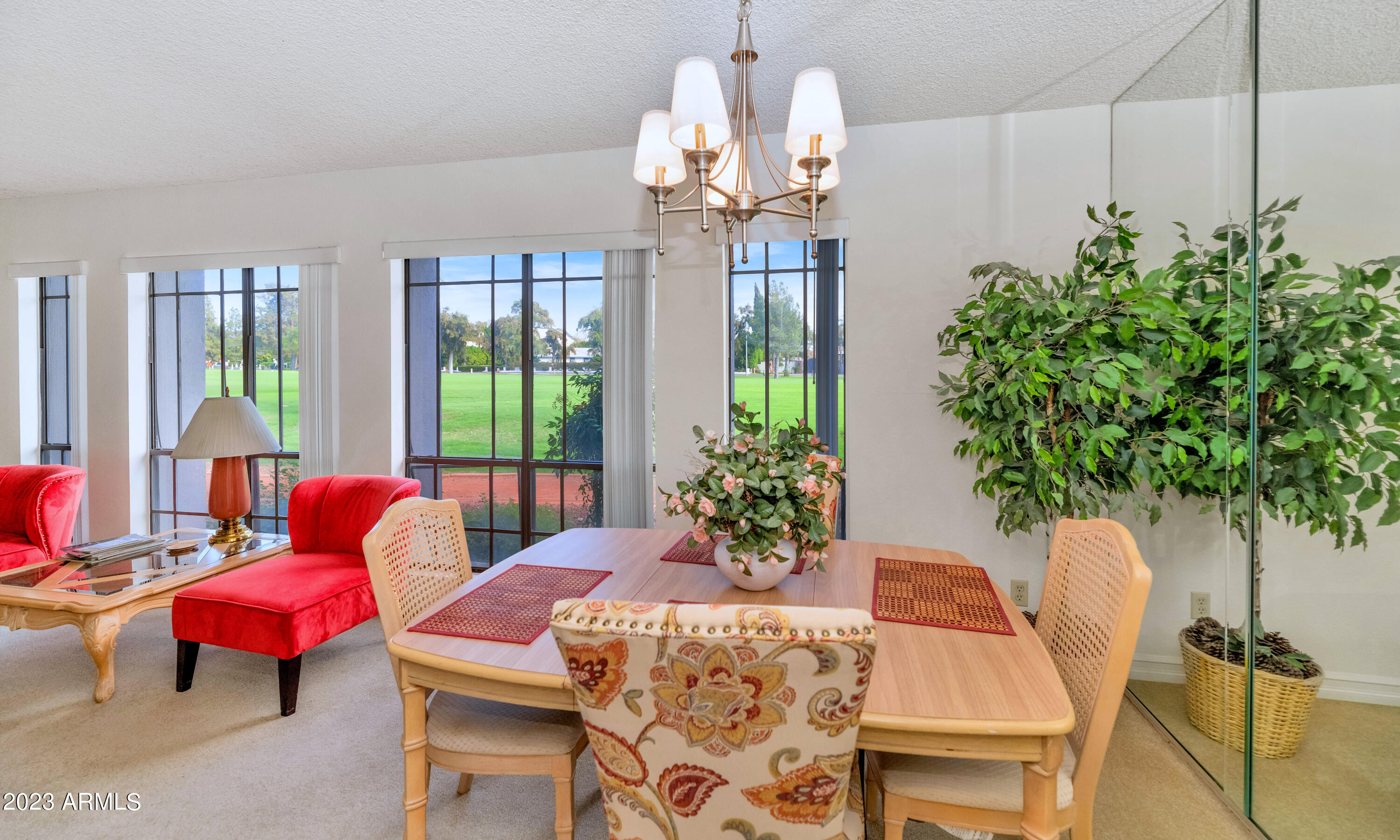 5223 North 24th Street, Unit 105 Phoenix, AZ 85016 - Photo 6 of 22 a dining room with furniture a potted plant and a large window