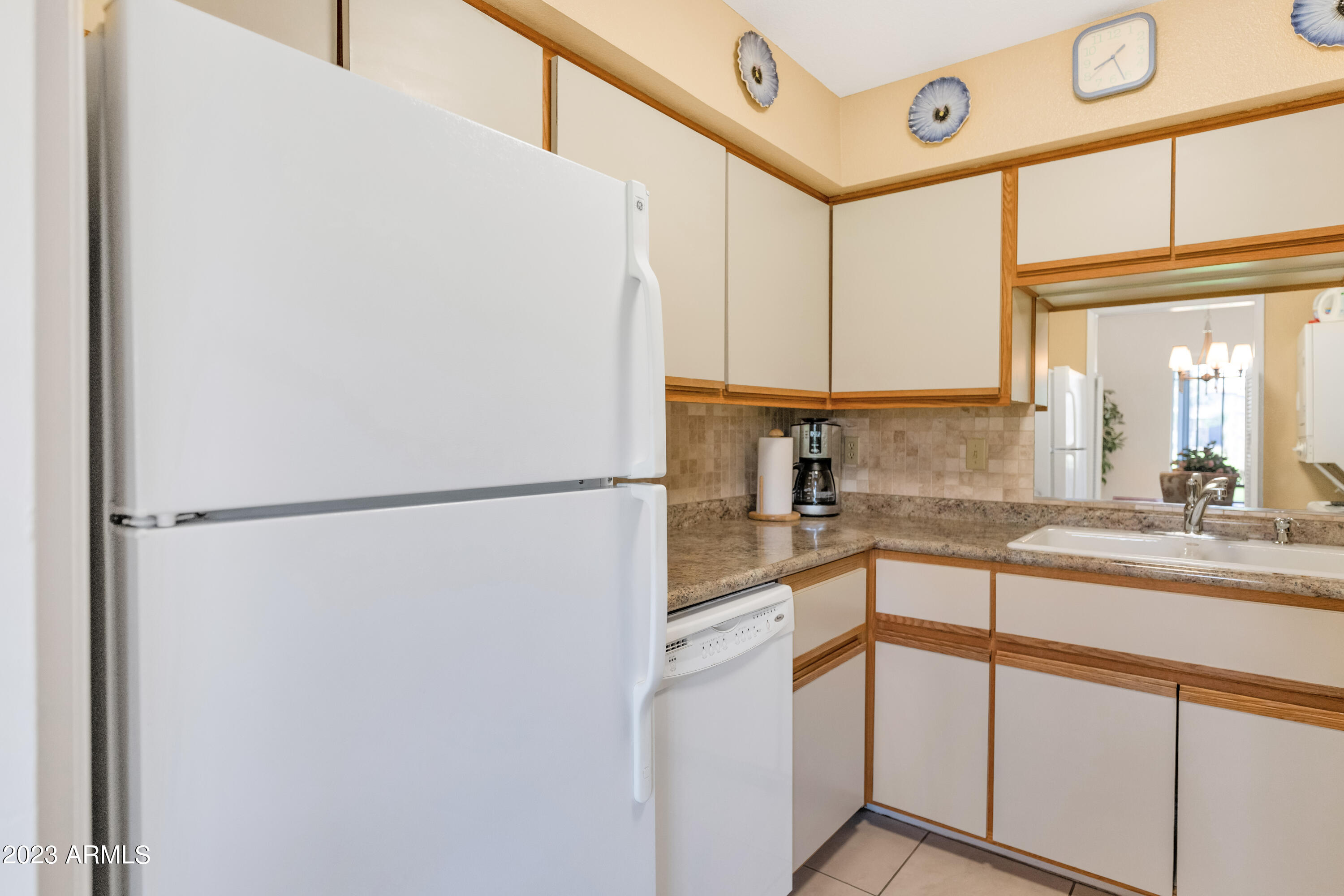 5223 North 24th Street, Unit 105 Phoenix, AZ 85016 - Photo 7 of 22 a kitchen with stainless steel appliances a refrigerator sink and cabinets