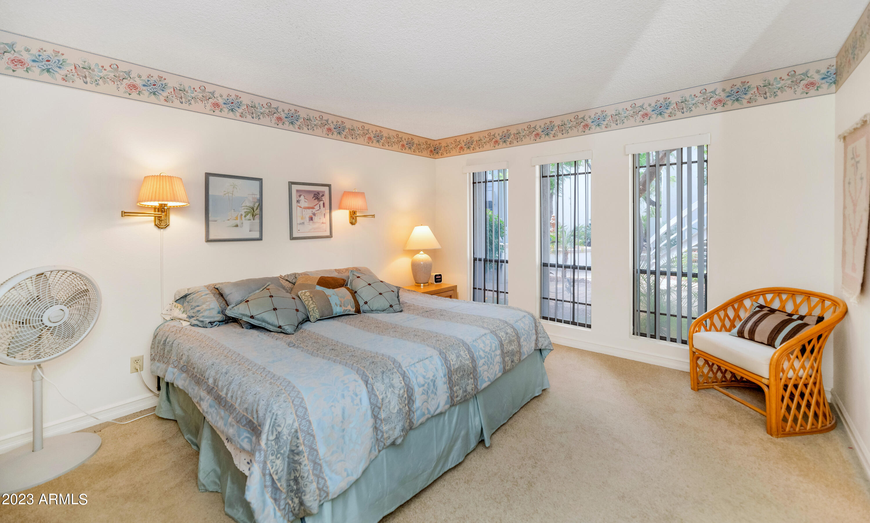 5223 North 24th Street, Unit 105 Phoenix, AZ 85016 - Photo 10 of 22 a spacious bedroom with a bed and a couch