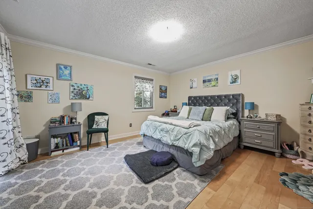 a bedroom with a bed and a desk