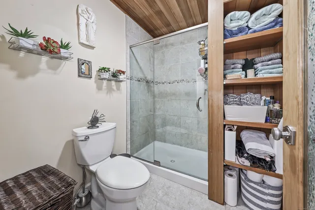 a bathroom with a toilet and a shower