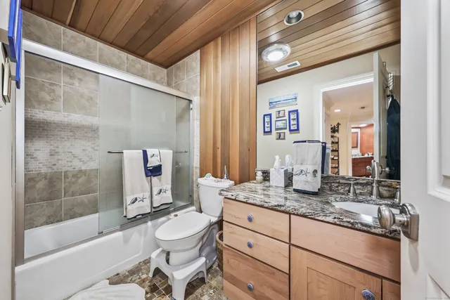 a view of a patio with couches and a table and chairs with wooden floor