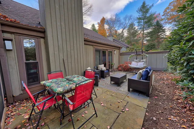 a view of a patio with couches table and chairs and potted plants
