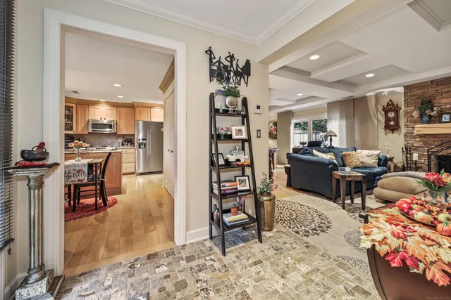 a living room with furniture a rug and a kitchen view