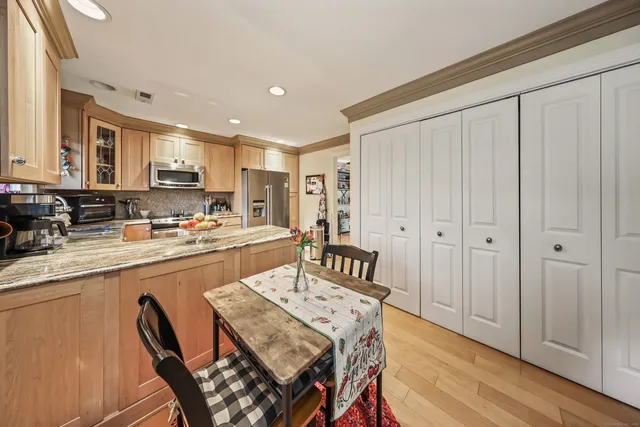 a large kitchen with a table and chairs in it