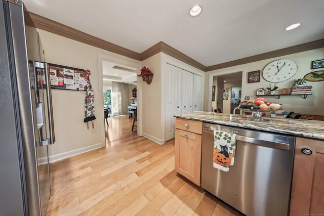 a kitchen with stainless steel appliances granite countertop a refrigerator and a sink