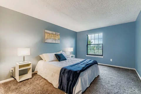 a bedroom with bed and a window