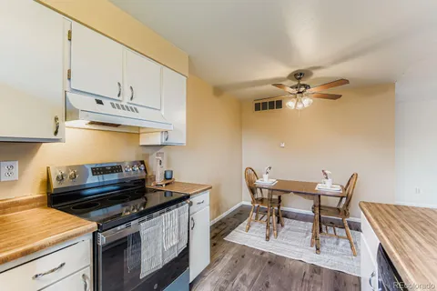 a kitchen with stainless steel appliances a stove a sink and cabinets
