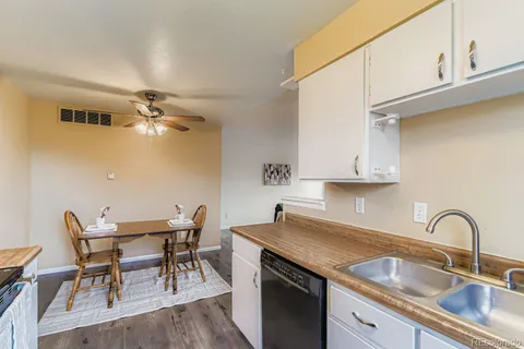 a kitchen with a sink cabinets and dining table