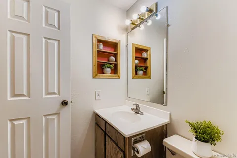 a bathroom with a sink a toilet and mirror