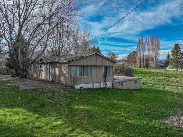 a view of a house with a yard and sitting area