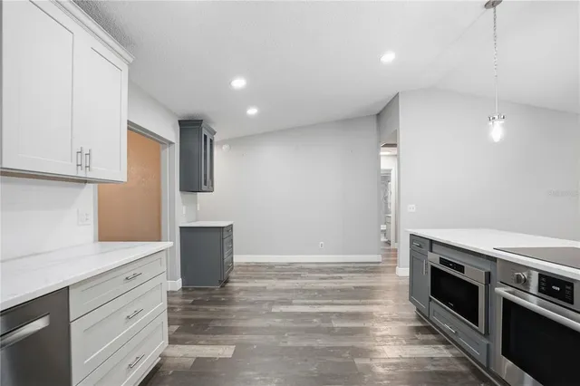 a kitchen with stainless steel appliances granite countertop a refrigerator and a sink