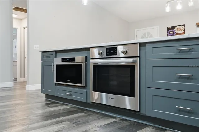 a kitchen with appliances a sink and a refrigerator