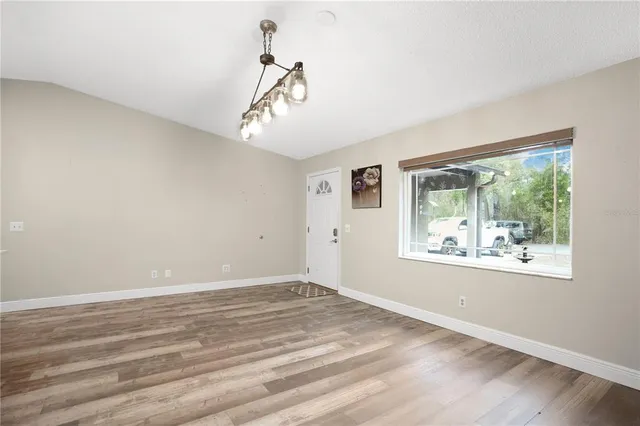 a large kitchen with stainless steel appliances kitchen island a large counter top a stove a refrigerator and a sink