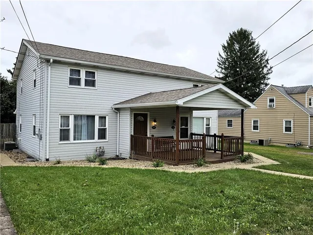 a front view of house with yard and green space