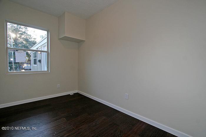 1405 Griflet Road Jacksonville, FL 32211 - Photo 9 of 13 a view of a small space with wooden floor and a window