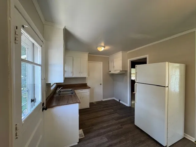 a kitchen with a refrigerator a stove and a sink
