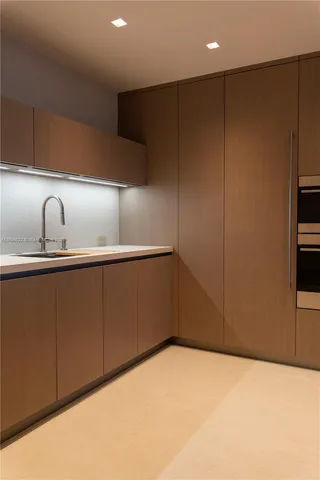 a kitchen with a refrigerator and cabinets