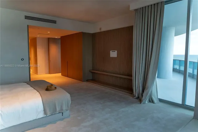 a bedroom with a bed and a lamp