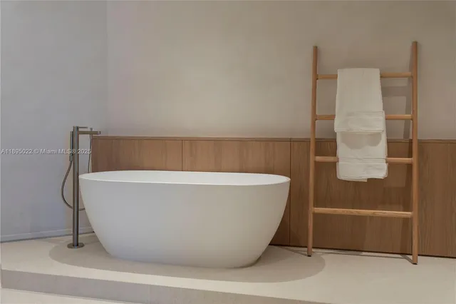 a white bath tub sitting next to a white sink
