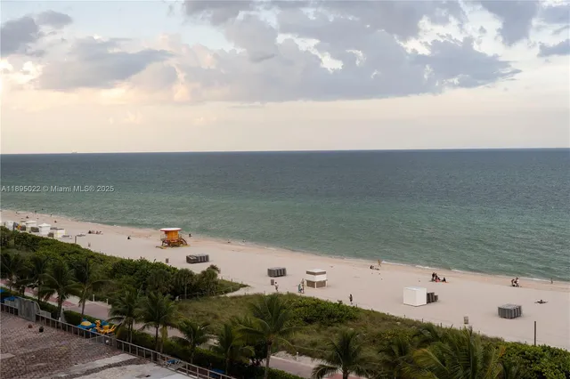a view of building with sign board and yard