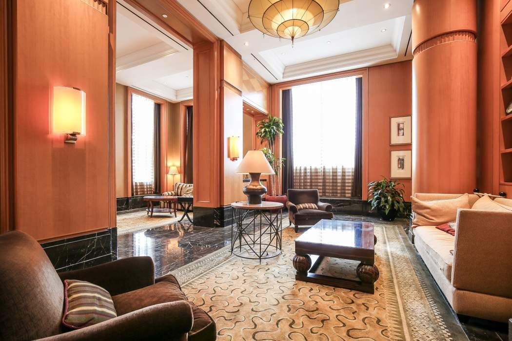 220 Riverside Boulevard, Unit 5L Manhattan, NY 10069 - Photo 12 of 16 a living room with furniture and large windows