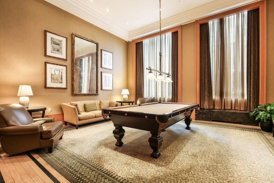 220 Riverside Boulevard, Unit 5L Manhattan, NY 10069 - Photo 13 of 16 a living room with furniture pool table and a window